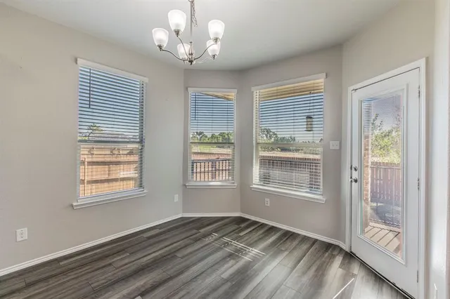 a view of kitchen with cabinets and wooden floor