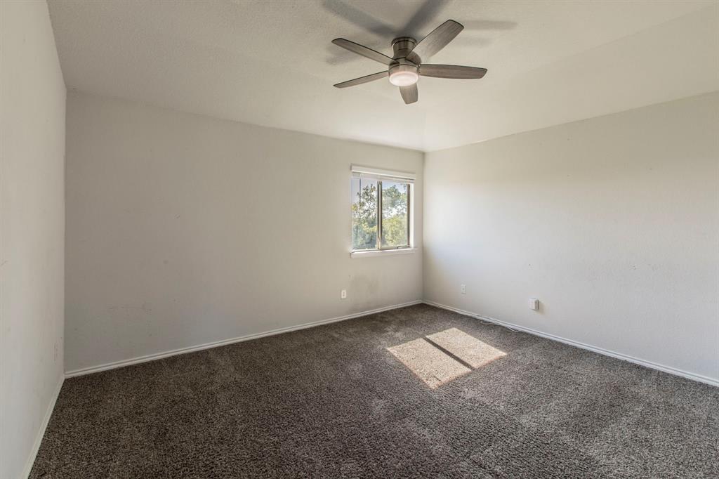 6401 Elephant Butte Drive Waco, TX 76708 - Photo 18 of 34 an empty room with chandelier fan and windows