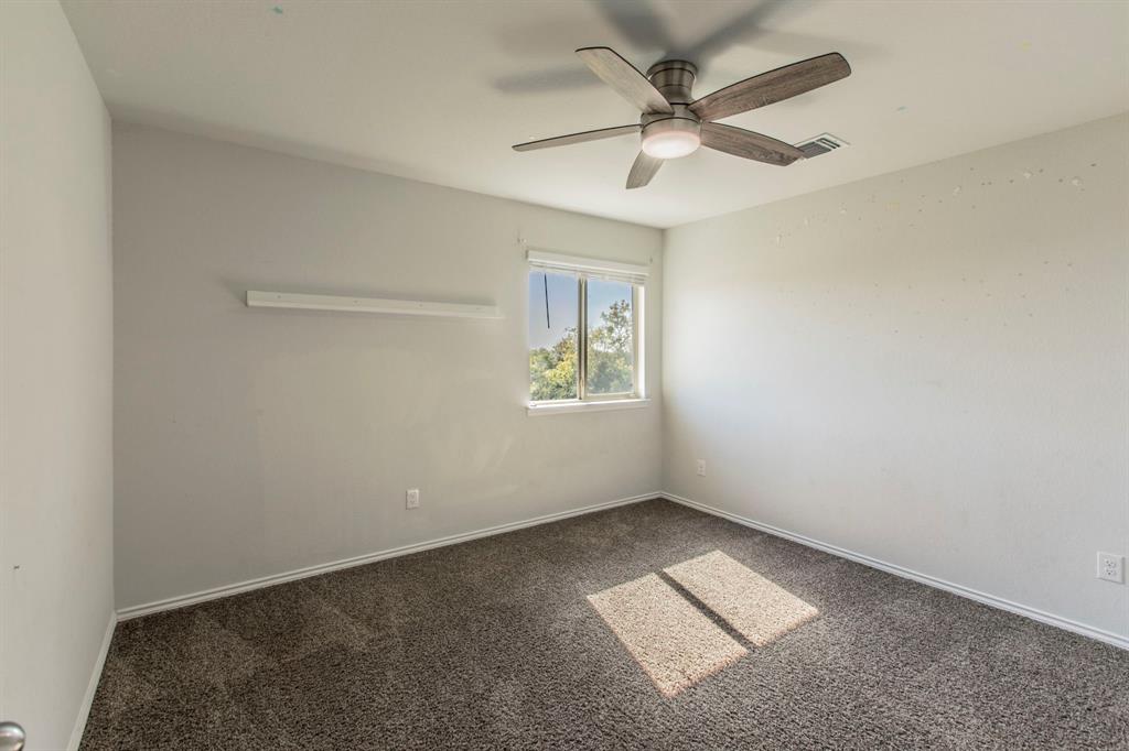 6401 Elephant Butte Drive Waco, TX 76708 - Photo 20 of 34 an empty room with a window and a ceiling fan