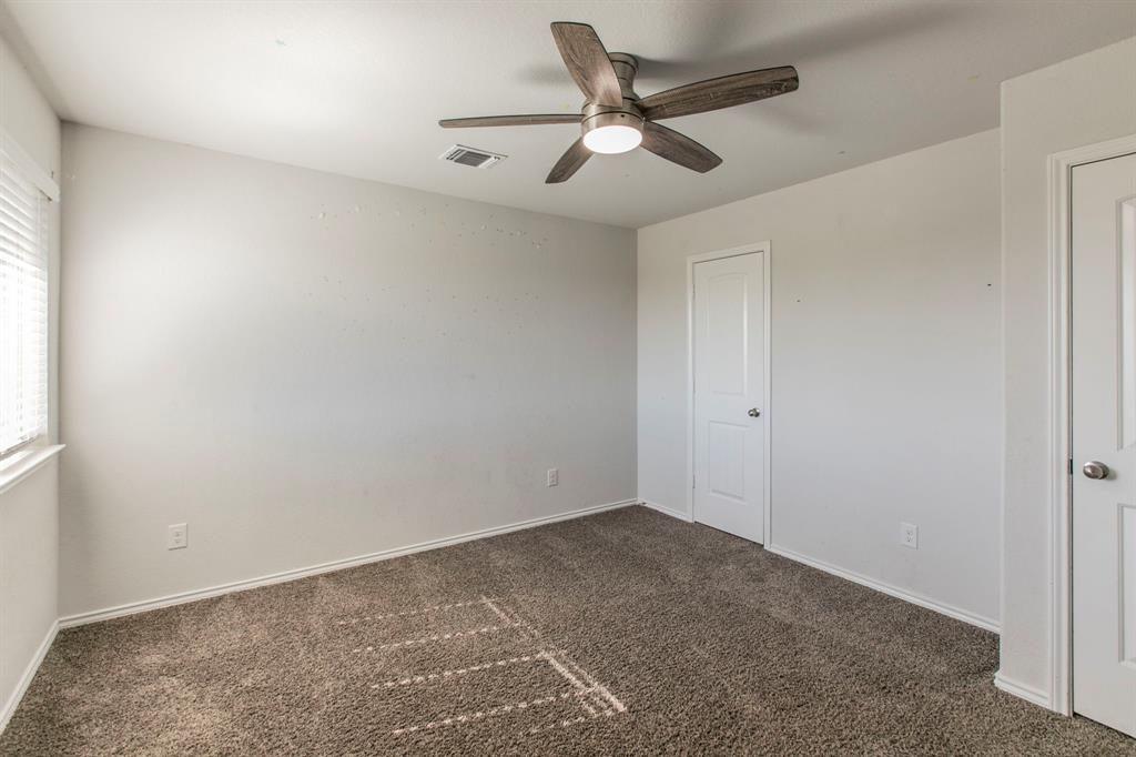 6401 Elephant Butte Drive Waco, TX 76708 - Photo 21 of 34 an empty room with a ceiling fan and wooden floor