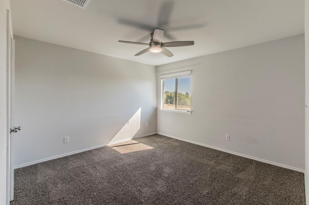 6401 Elephant Butte Drive Waco, TX 76708 - Photo 22 of 34 an empty room with windows and fan