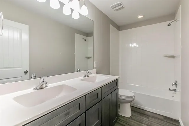 an empty room with a window and a ceiling fan