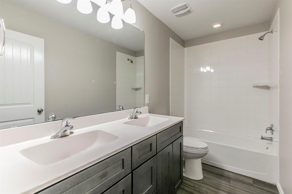 6401 Elephant Butte Drive Waco, TX 76708 - Photo 24 of 34 a bathroom with a sink a toilet and shower