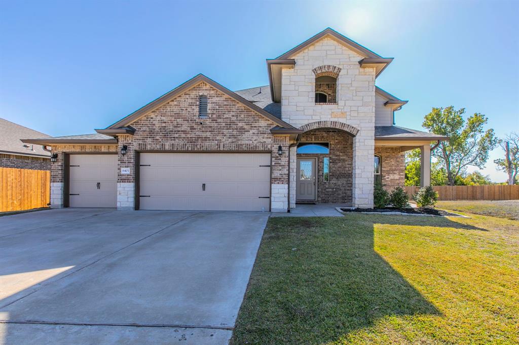 6401 Elephant Butte Drive Waco, TX 76708 - Photo 3 of 34 a front view of a house with a yard and garage