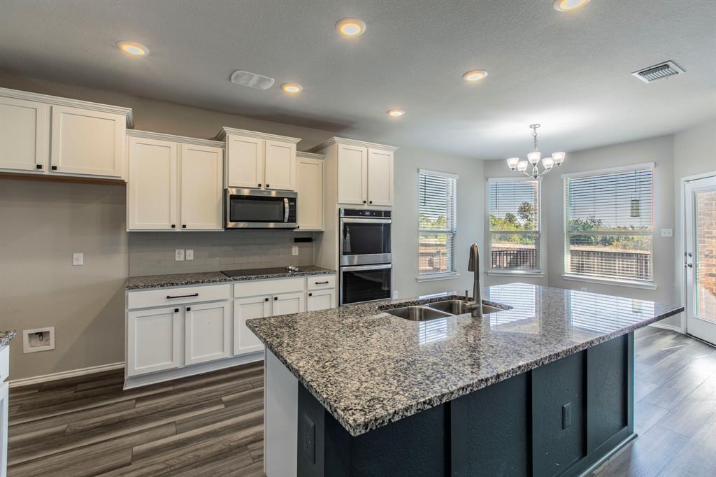 6401 Elephant Butte Drive Waco, TX 76708 - Photo 8 of 34 a kitchen with kitchen island granite countertop a stove oven and a sink with granite countertops