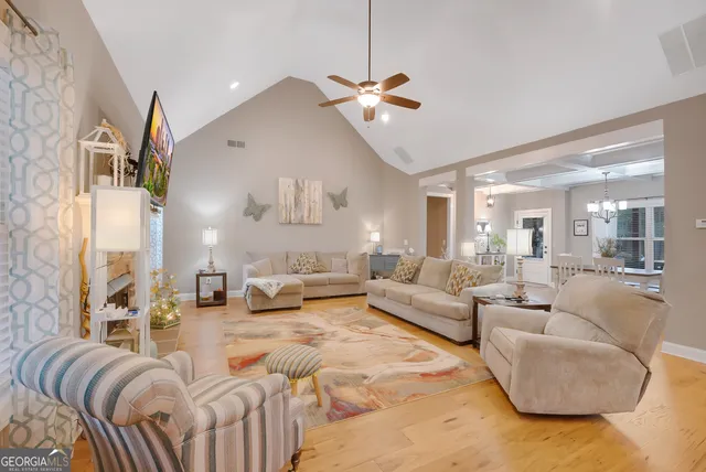 a living room with furniture and a chandelier