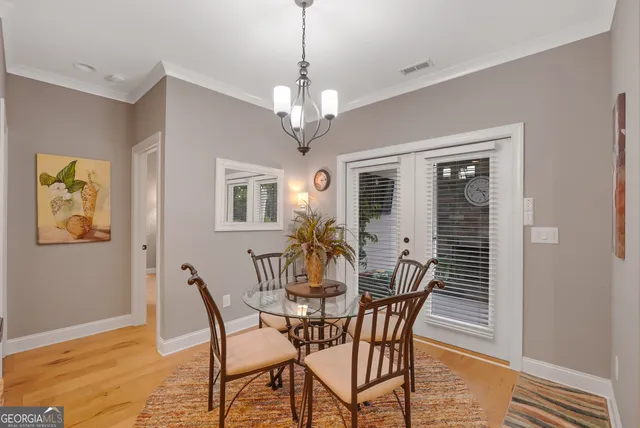 a view of a dining room with furniture and chandelier