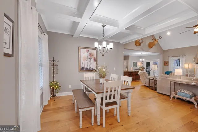 a view of a dining room with furniture and chandelier