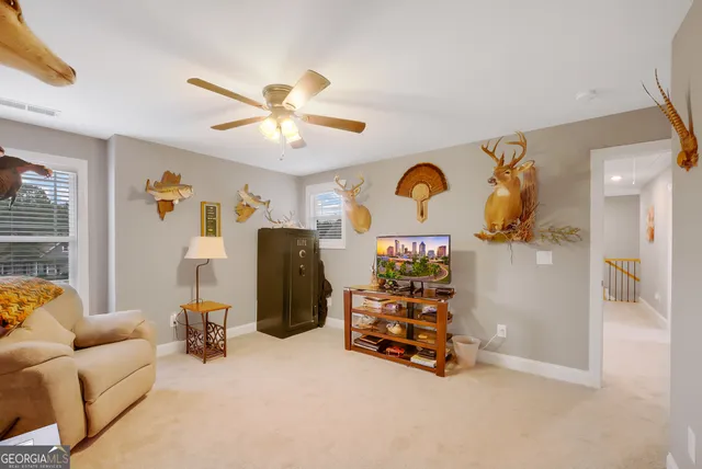 a view of a livingroom with furniture and a ceiling fan
