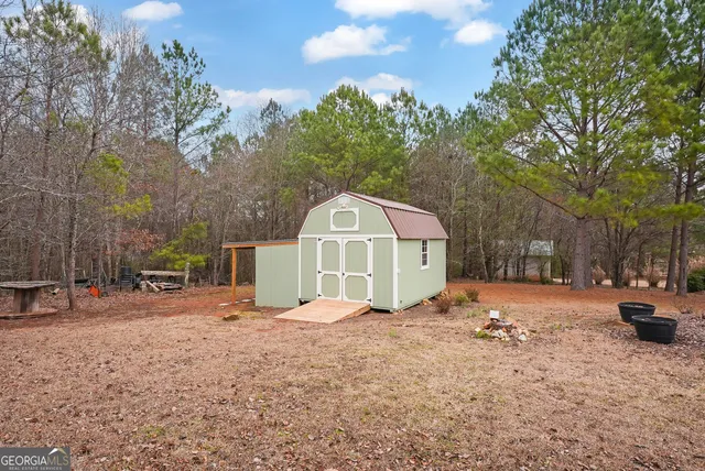 a front view of a house with a yard covered in snow