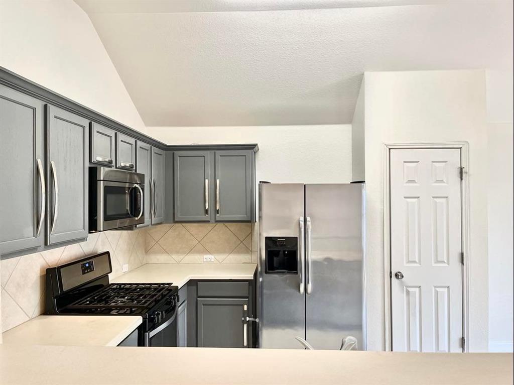 2409 Romeo Drive Cedar Park, TX 78613 - Photo 4 of 22 a kitchen with a refrigerator and a stove top oven