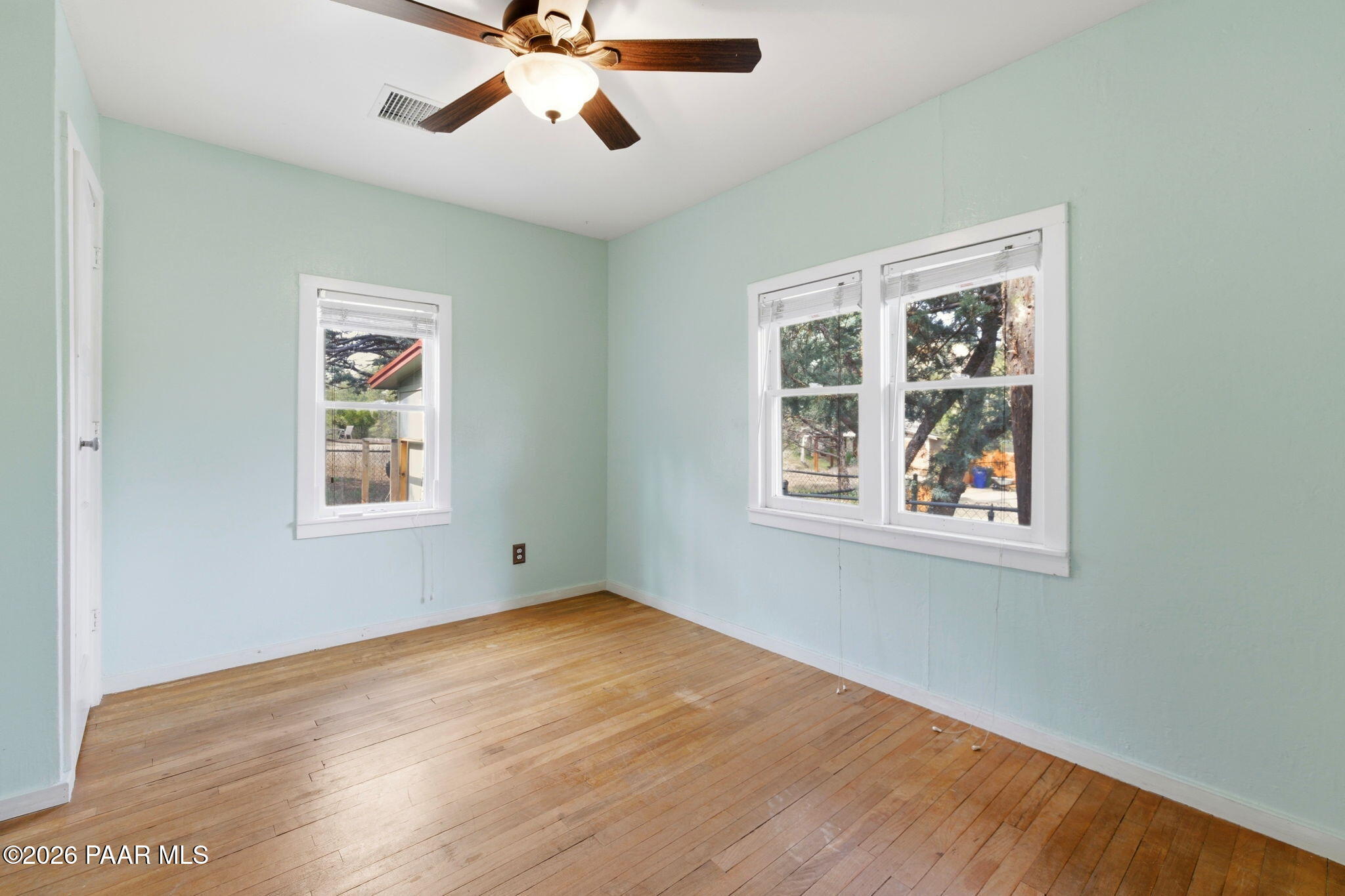 1701 Idylwild Road Prescott, AZ 86305 - Photo 8 of 26 a view of an empty room with wooden floor and a window