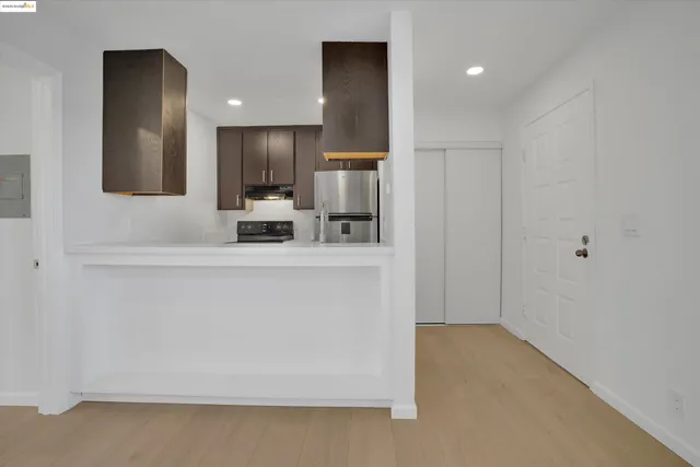 a view of a kitchen with a sink and a refrigerator