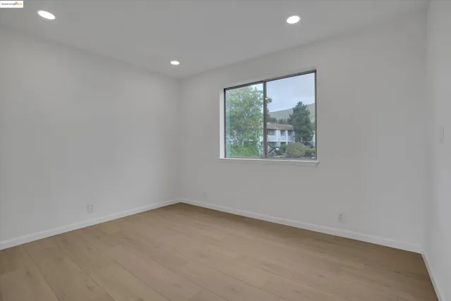 a bedroom with a large bed and potted plant