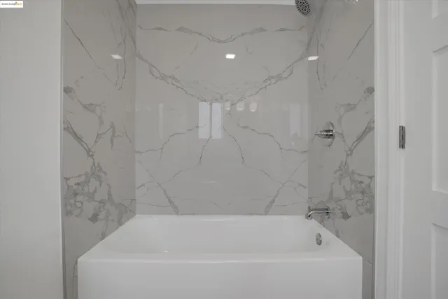 a bathroom with a sink a light fixture and a mirror