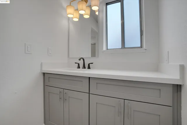 a bathroom with a glass shower door and a sink
