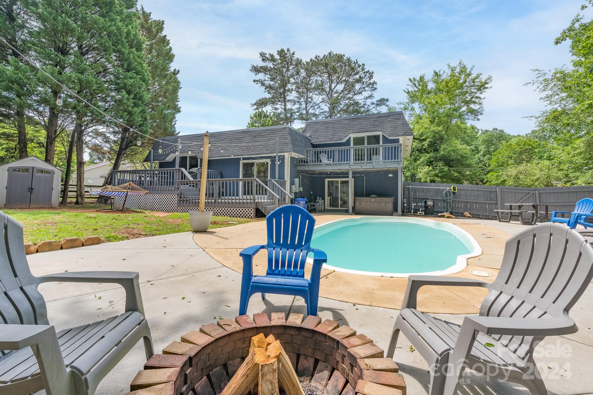 4093 Marquesas Avenue Tega Cay, SC 29708 - Photo 1 of 38 a view of a patio with table and chairs potted plants and large tree