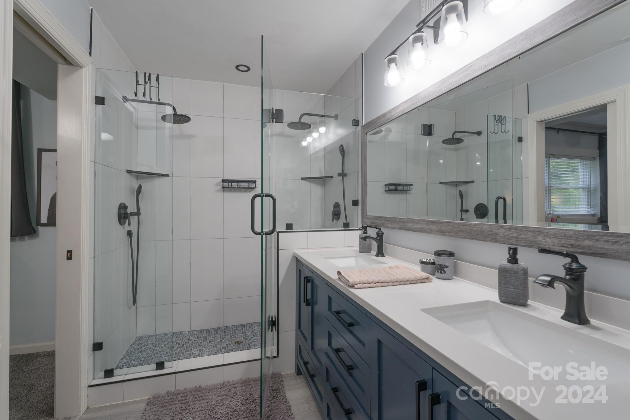 4093 Marquesas Avenue Tega Cay, SC 29708 - Photo 5 of 38 a bathroom with a double vanity sink mirror and shower