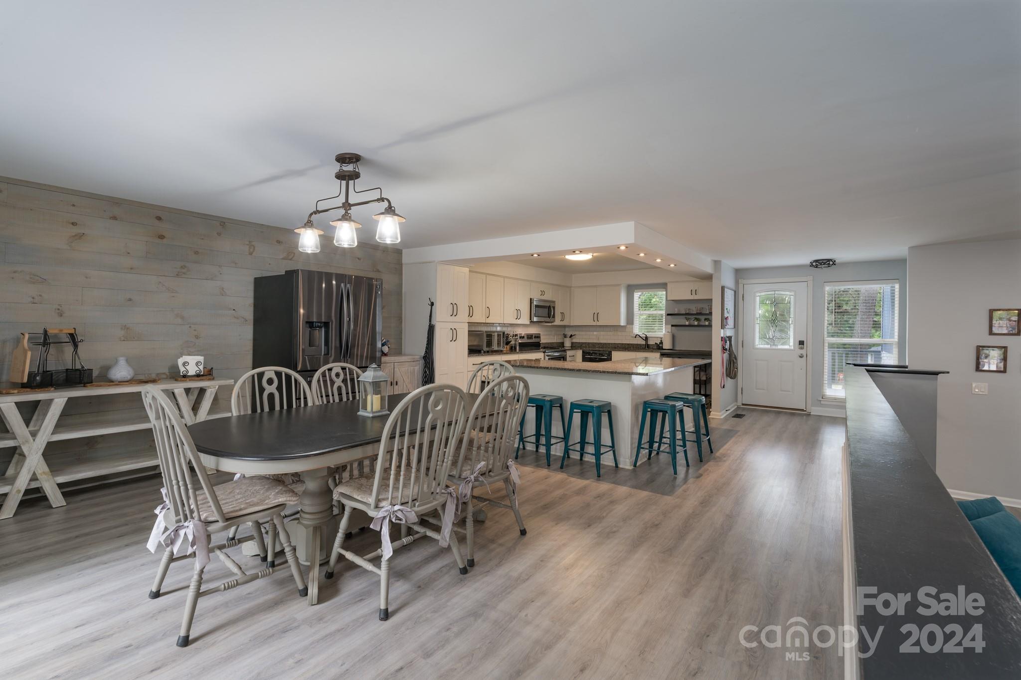 4093 Marquesas Avenue Tega Cay, SC 29708 - Photo 9 of 38 a view of a dining room with furniture and wooden floor