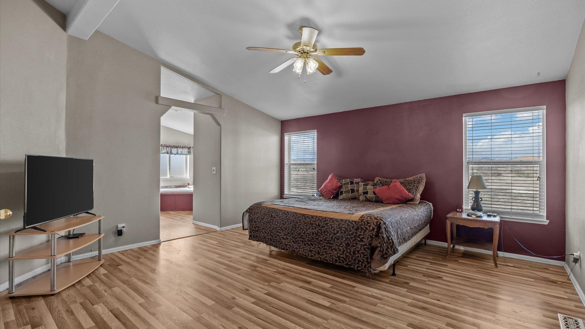 710 Old Highway Mack, CO 81525 - Photo 12 of 40 a bedroom with a bed and a chandelier