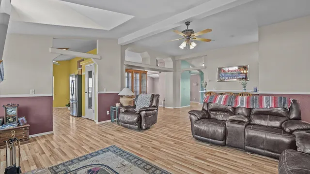 a living room with furniture and wooden floor