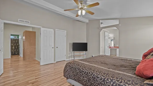 a bedroom with a bed and a flat screen tv