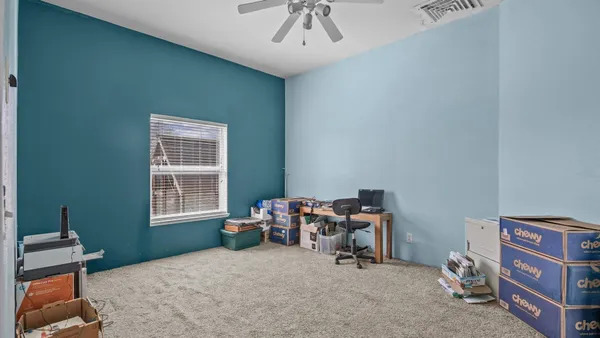 a bedroom with furniture and a window