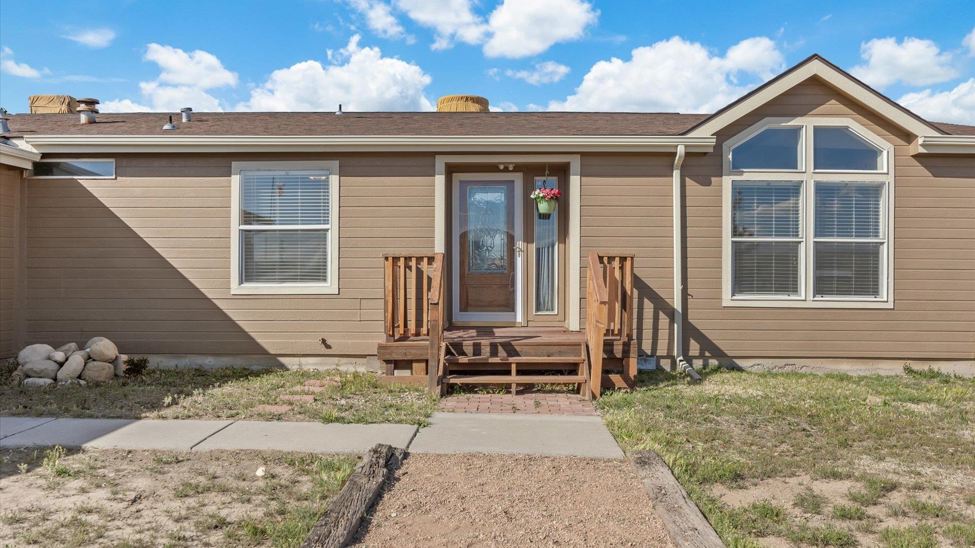 710 Old Highway Mack, CO 81525 - Photo 3 of 41 a front view of a house with a yard