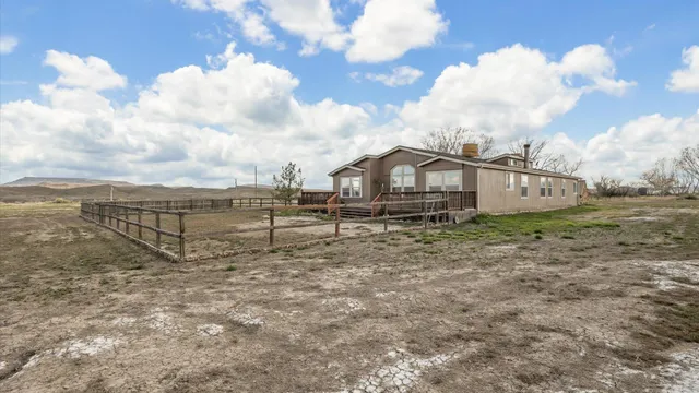 a view of a house with wooden fence