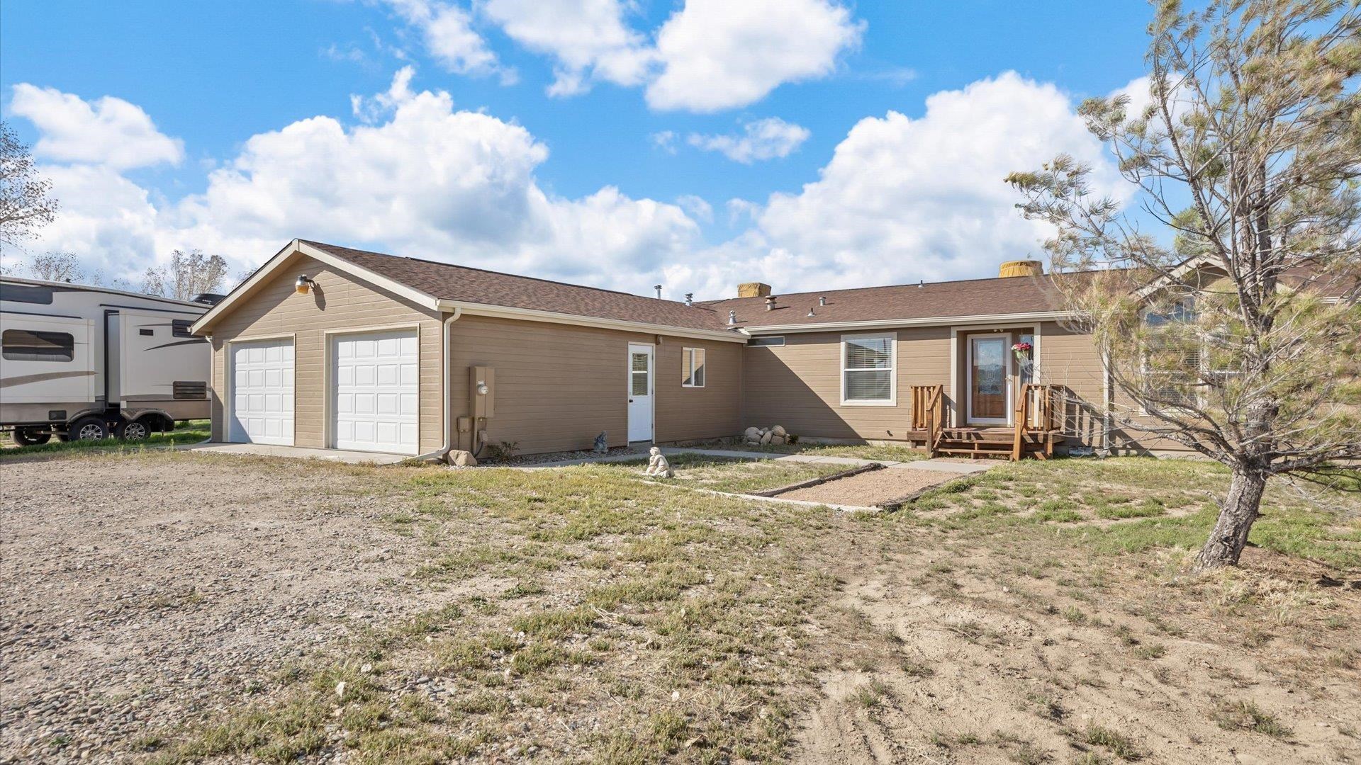 710 Old Highway Mack, CO 81525 - Photo 4 of 41 a view of a house with a yard and large tree