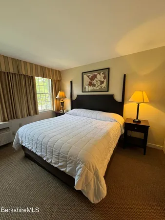 a bedroom with a bed and dresser