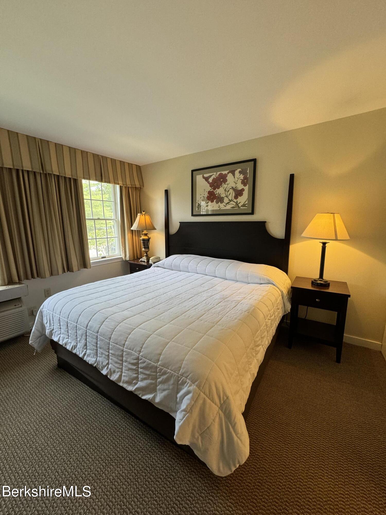 37 Corey Road, Unit 212 Hancock, MA 01237 - Photo 12 of 19 a bedroom with a bed and dresser