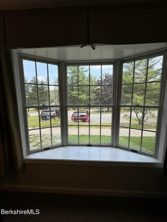 a kitchen with a table chairs and white cabinets