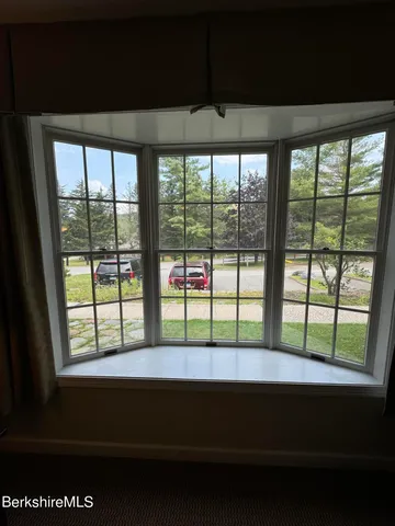 a kitchen with a table chairs and white cabinets
