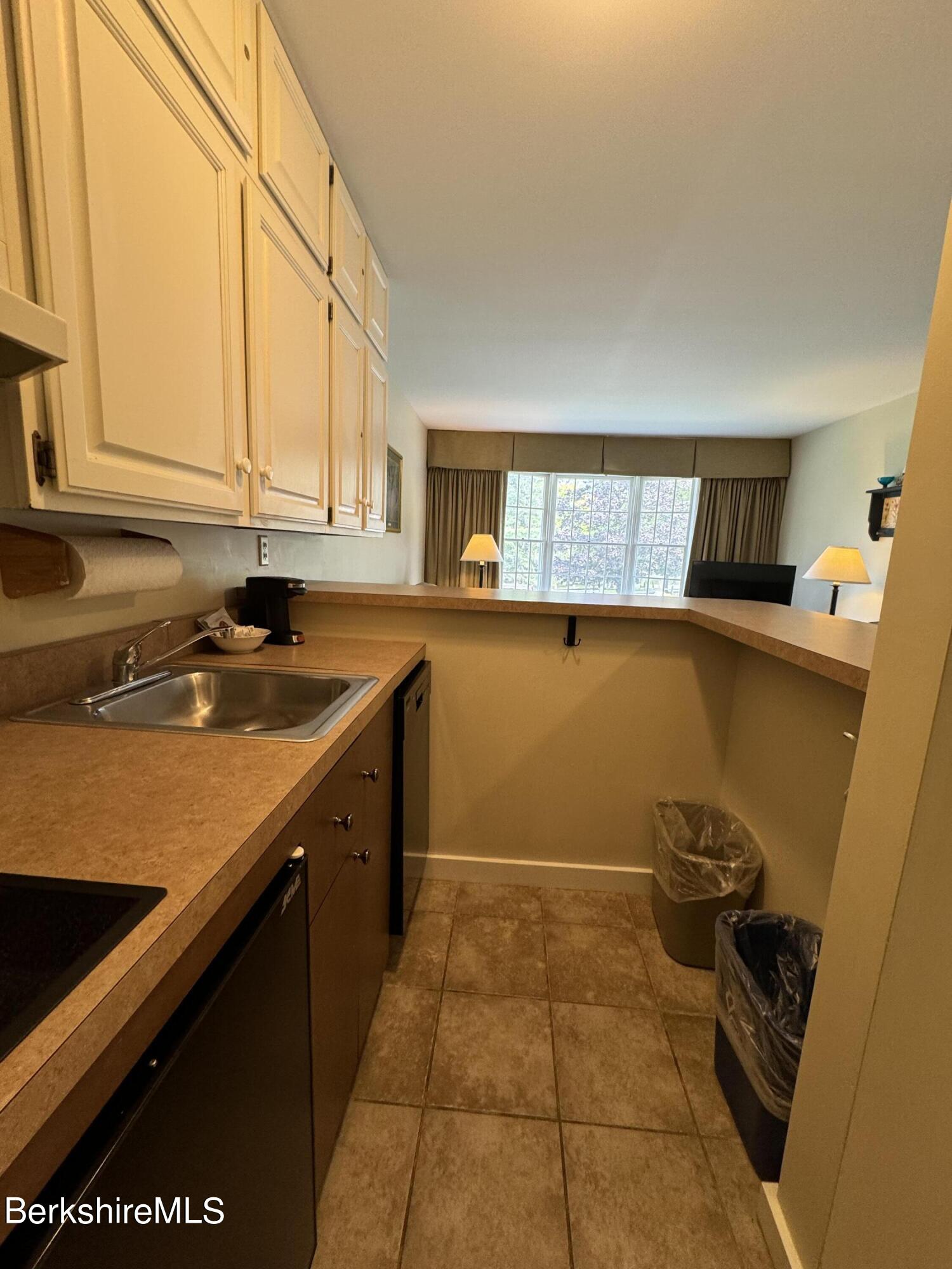 37 Corey Road, Unit 212 Hancock, MA 01237 - Photo 17 of 19 a kitchen with a sink a stove and cabinets