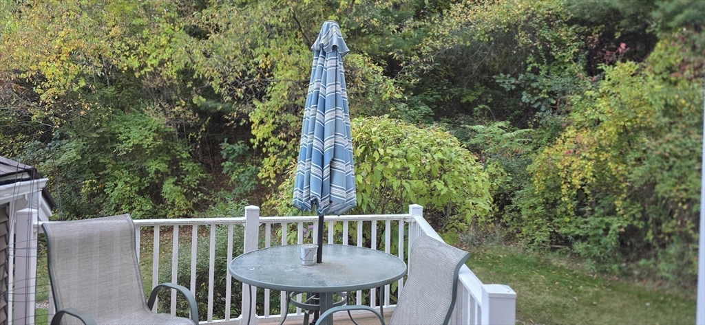 61 Southview Drive, Unit 61 Southwick, MA 01077 - Photo 11 of 28 a view of a balcony with a table and chairs