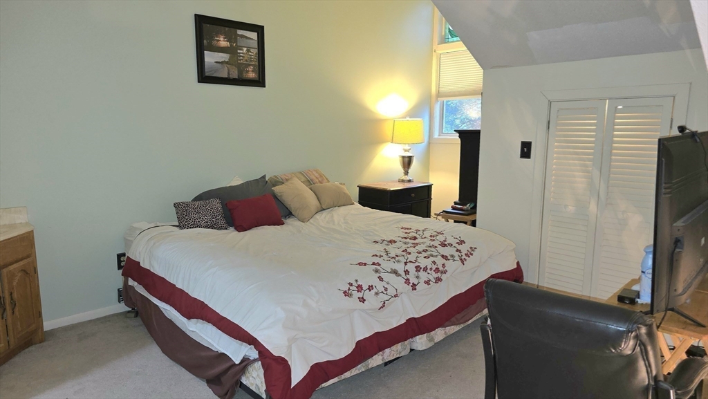 61 Southview Drive, Unit 61 Southwick, MA 01077 - Photo 14 of 28 a bedroom with a bed and a window