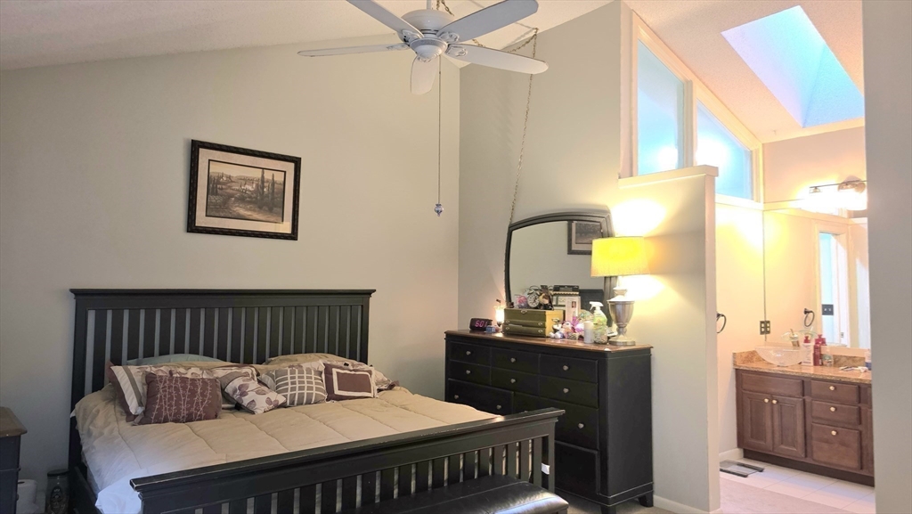 61 Southview Drive, Unit 61 Southwick, MA 01077 - Photo 16 of 28 a bedroom with a bed and wooden floor