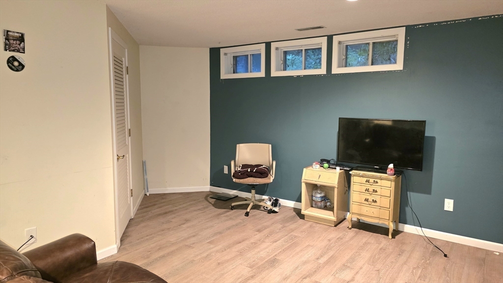 61 Southview Drive, Unit 61 Southwick, MA 01077 - Photo 18 of 28 a room with furniture and wooden floor