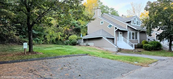 a front view of house with yard and green space