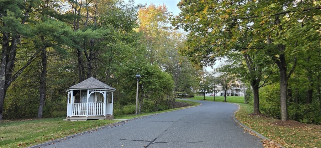 61 Southview Drive, Unit 61 Southwick, MA 01077 - Photo 21 of 28 a front view of a house with a yard and trees