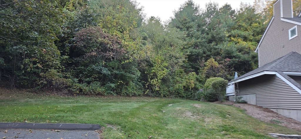 61 Southview Drive, Unit 61 Southwick, MA 01077 - Photo 22 of 28 a view of a backyard with potted plants and large trees