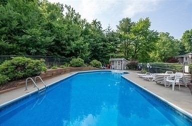 61 Southview Drive, Unit 61 Southwick, MA 01077 - Photo 24 of 28 a view of a swimming pool with chairs
