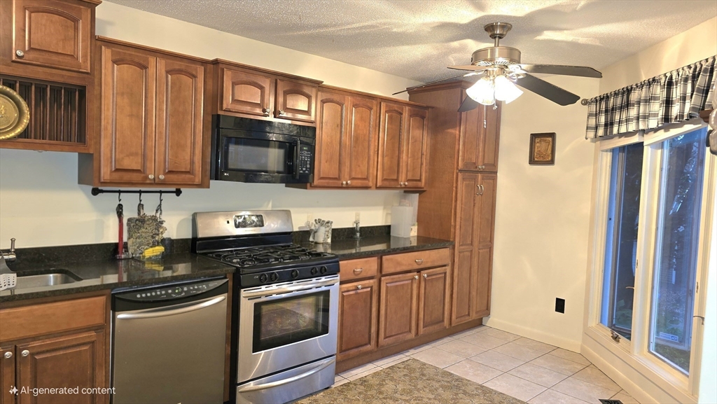 61 Southview Drive, Unit 61 Southwick, MA 01077 - Photo 4 of 28 a kitchen with stainless steel appliances granite countertop a stove a sink and a refrigerator