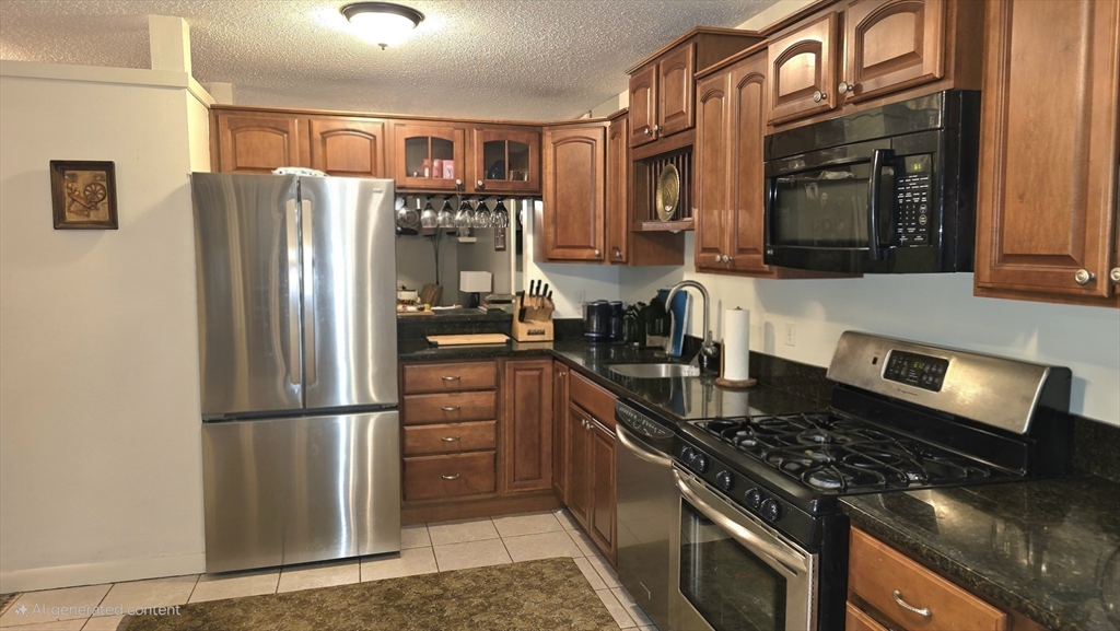 61 Southview Drive, Unit 61 Southwick, MA 01077 - Photo 5 of 28 a kitchen with stainless steel appliances granite countertop a refrigerator stove top oven and sink