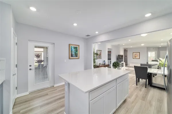a large kitchen with kitchen island a sink table and chairs