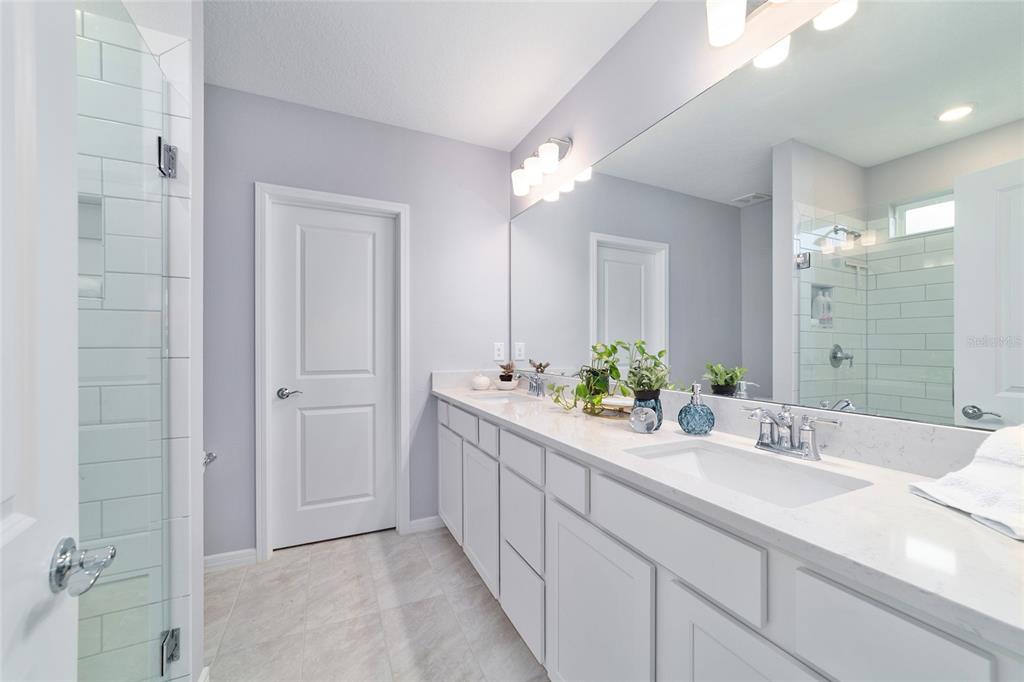 5472 Southwest 85th Ave Road Ocala, FL 34481 - Photo 19 of 44 a bathroom with a double vanity sink and a mirror