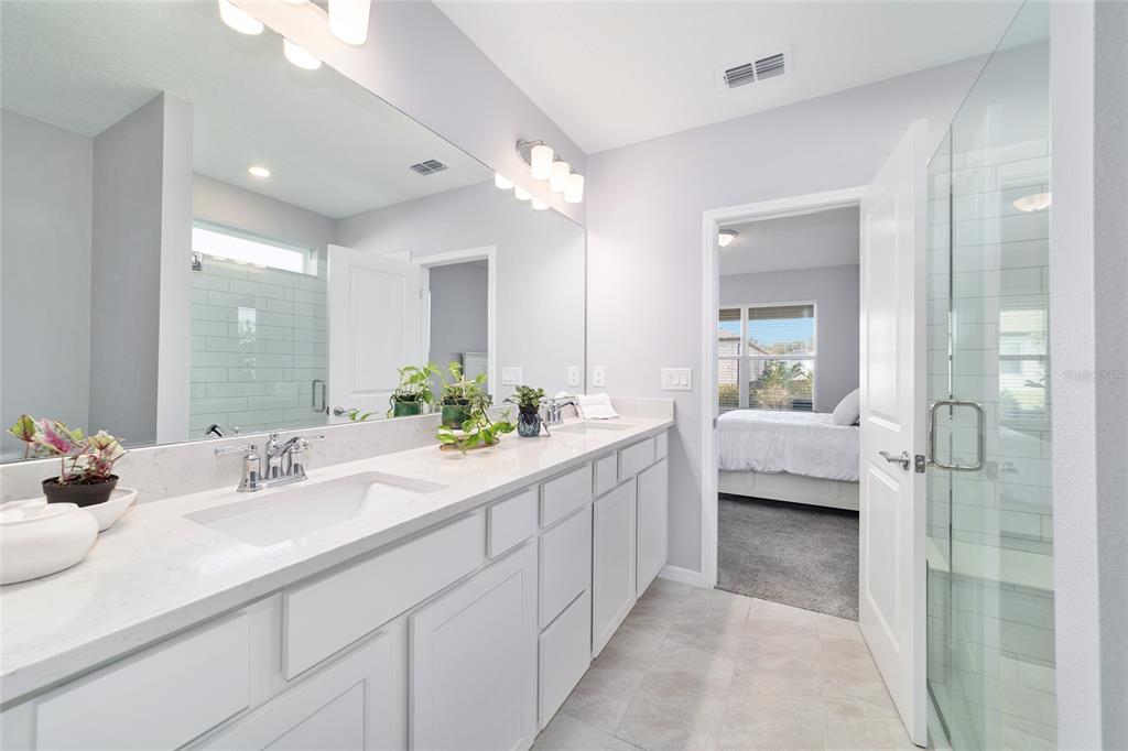 5472 Southwest 85th Ave Road Ocala, FL 34481 - Photo 20 of 44 a en suite bathroom with double vanity a sink and shower