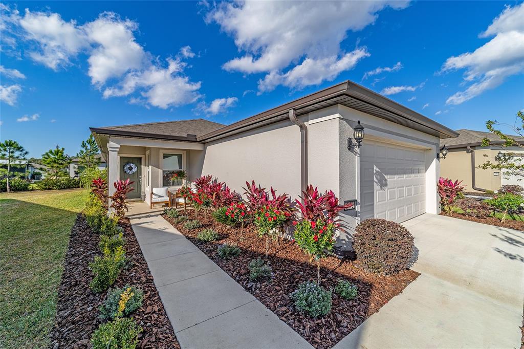 5472 Southwest 85th Ave Road Ocala, FL 34481 - Photo 2 of 44 a front view of a house with a yard