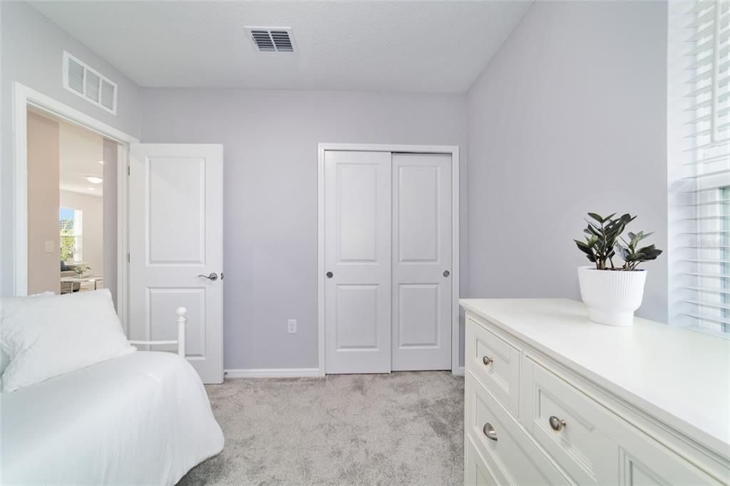 5472 Southwest 85th Ave Road Ocala, FL 34481 - Photo 24 of 44 a bedroom with a white bed and a dresser